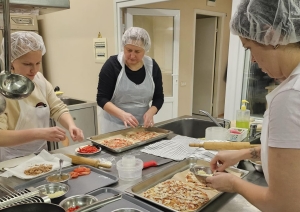Neformālās izglītības kursa “Pica – garšas eksplozija” dalībnieki praktiskajā nodarbībā gatavo picas, ievērojot bezatkritumu un ilgtspējīgas ēdienu gatavošanas principus.